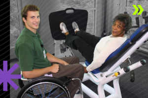 Young man in a wheelchair coaching an older woman using a leg press exercise machine